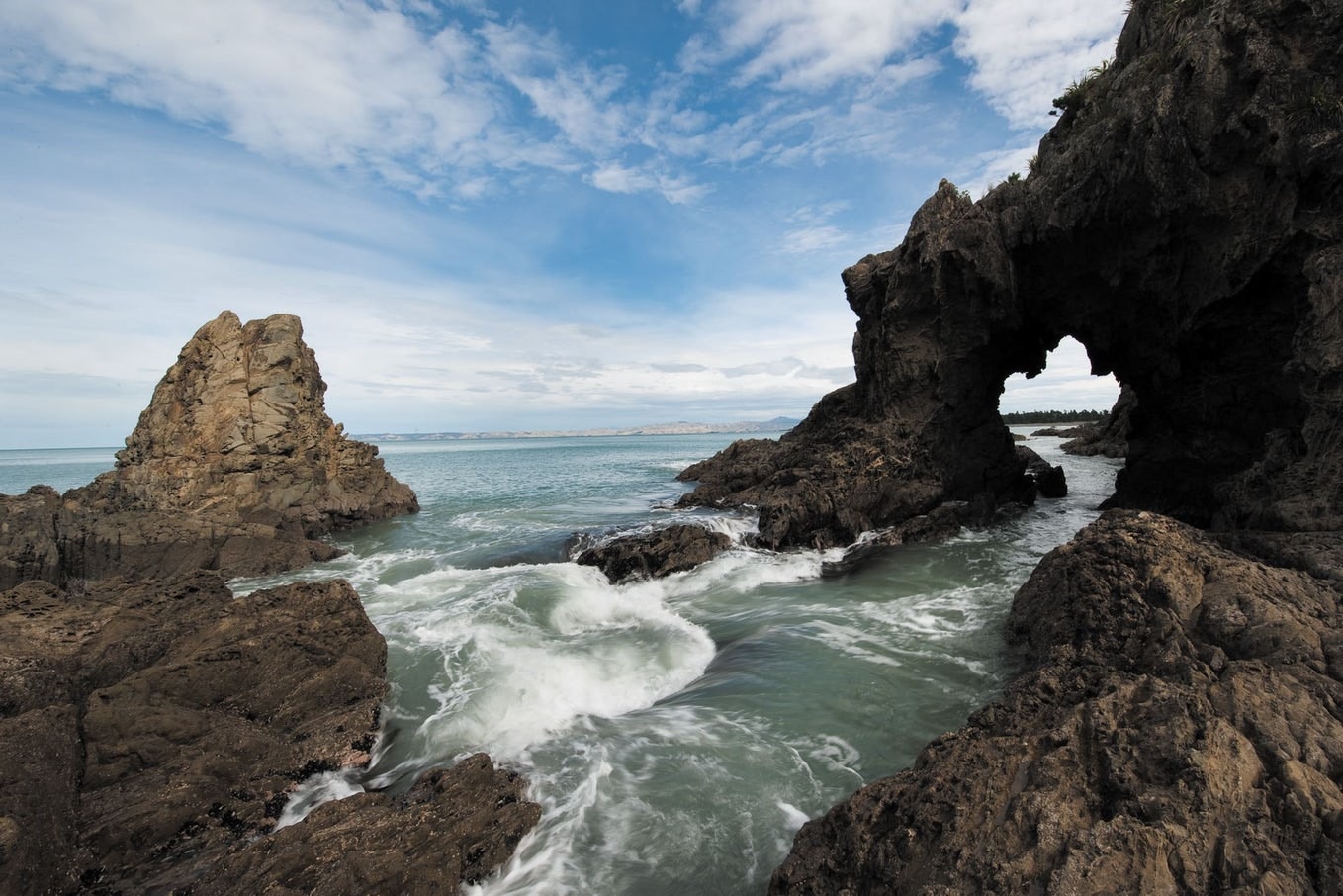Stunning coastal formations are a key feature fo the Abel Tasman track Water lapping up on eroded rocks at a beach