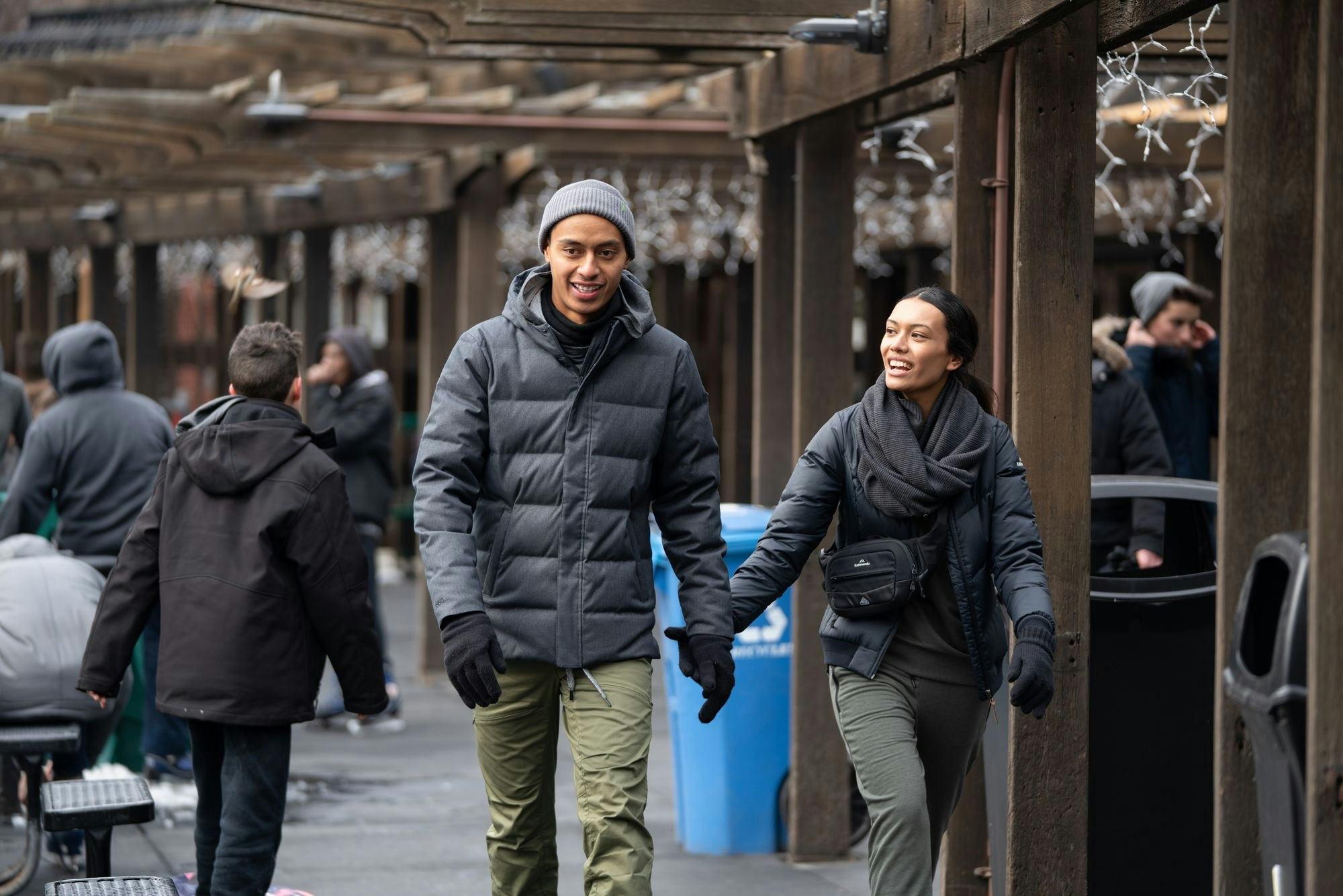 You'll want to continue wearing your comfy flight pants after you arrive A couple walking while wearing comfy flight pants