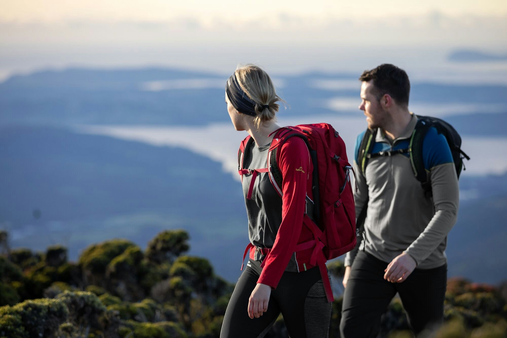 Wear your merino on the plane and also while hiking at your destination A couple hiking in merino