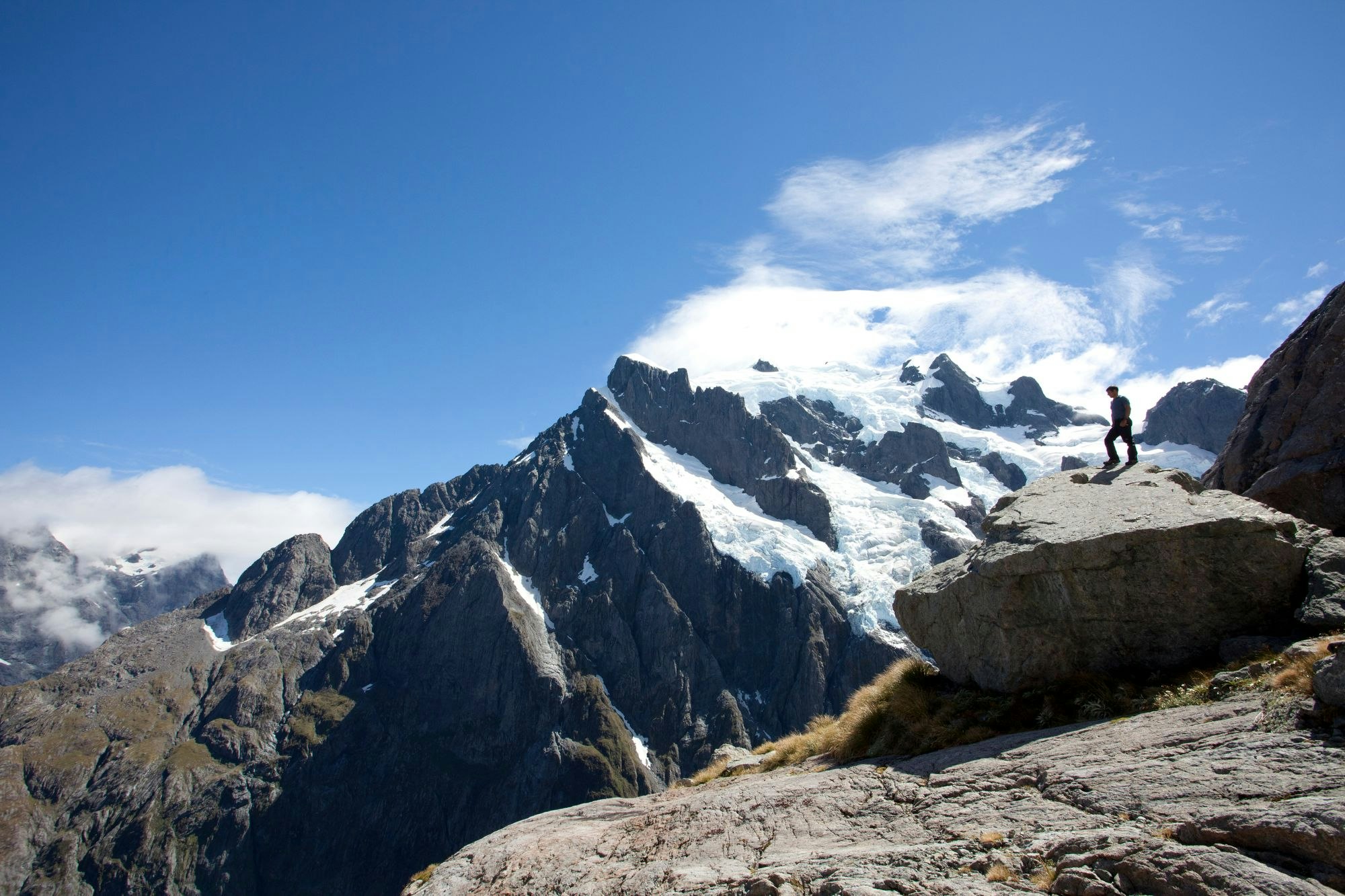 Man standing on rock on Routeburn Great Walk of New Zealand