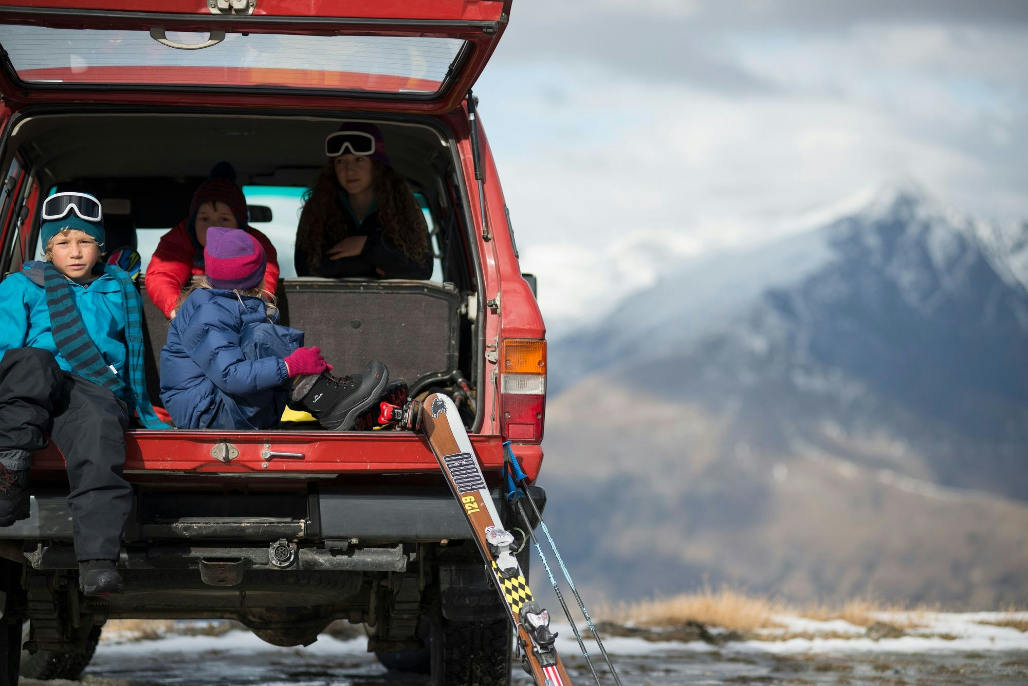 Both winter and summer activities are in abundance in Queenstown Some kids in the boot of a truck with skis
